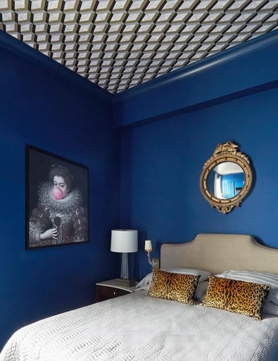 A bright blue bedroom design by Jasmin Reese: pop art, wallpaper ceiling, Chicago. 