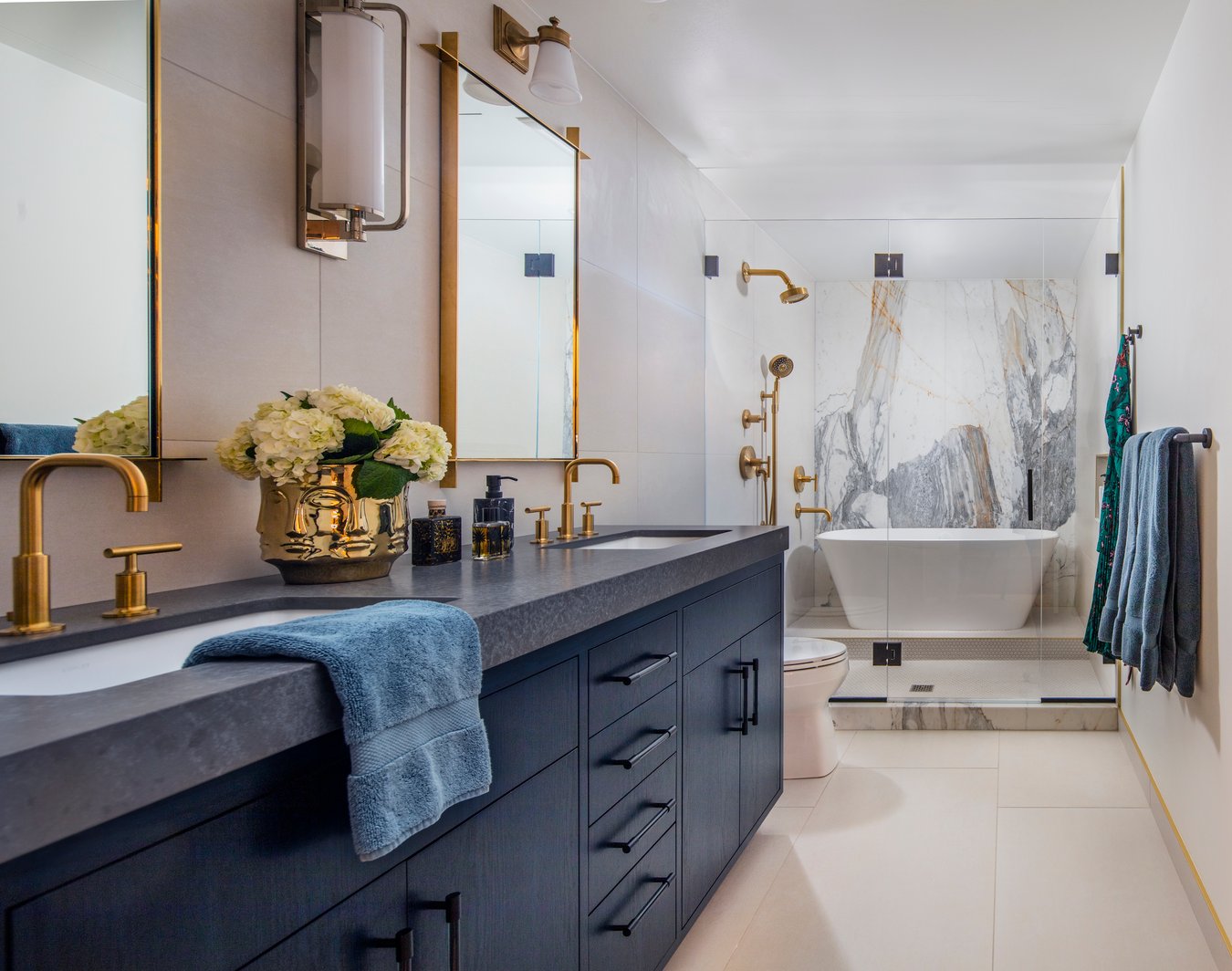 A full bathroom with double sinks & a tub & shower next to each other designed by Jasmin Reese, Chicago. 