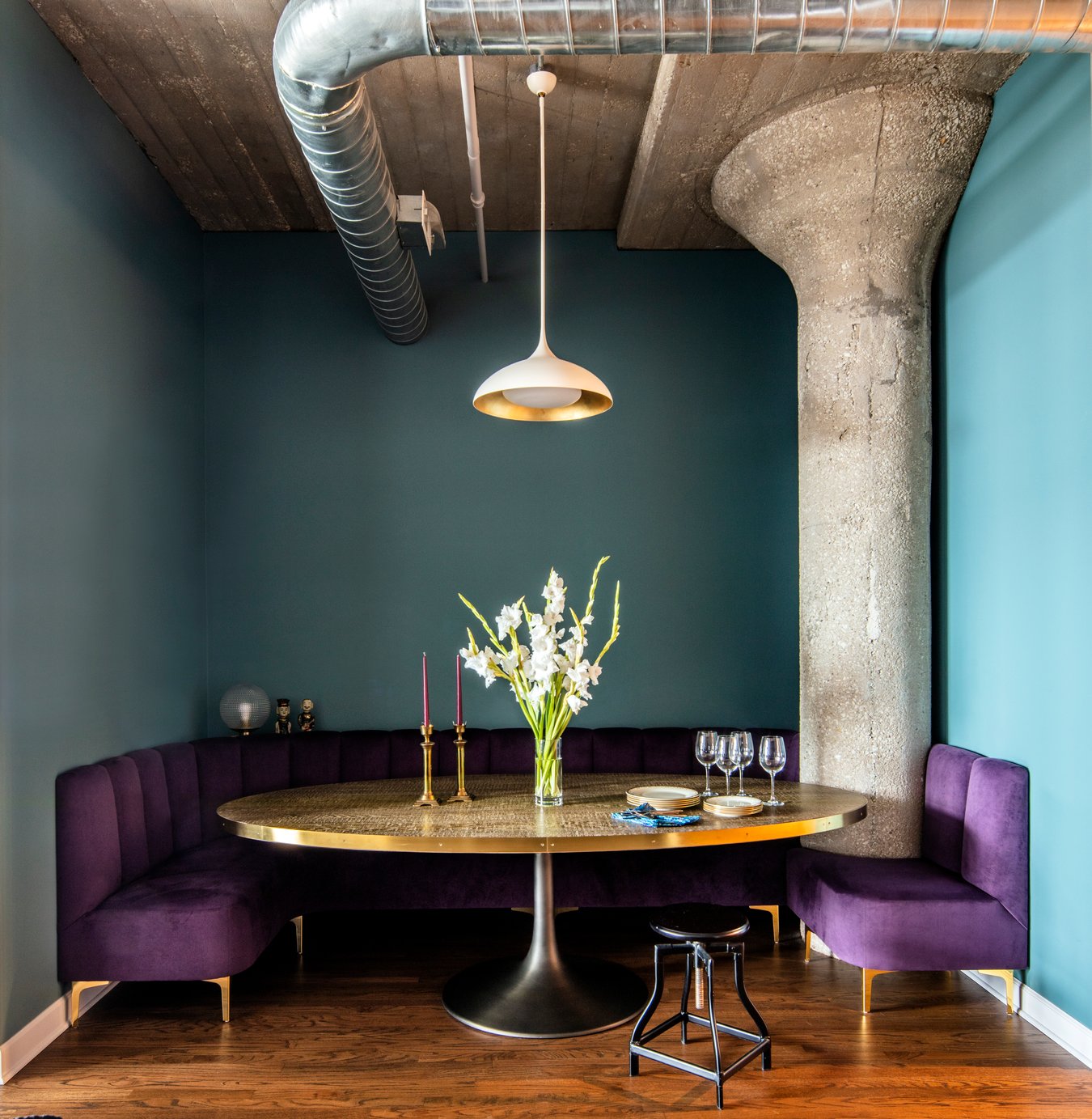 A purple, gold, and blue circular dining room designed by Jasmin Reese, Chicago. 