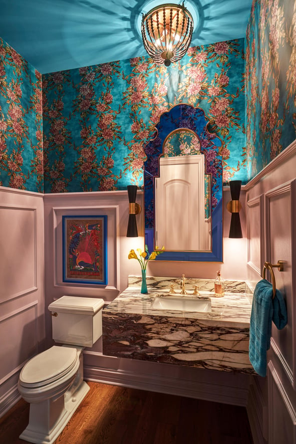 A small powder room with turquoise and pink floral wallpaper designed by Jasmin Reese Interiors, Chicago. 