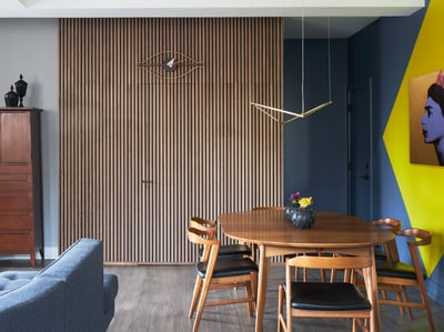 A modernist dining room designed by Jasmin Reese with wood slat and blue wall treatment, Chicago. 