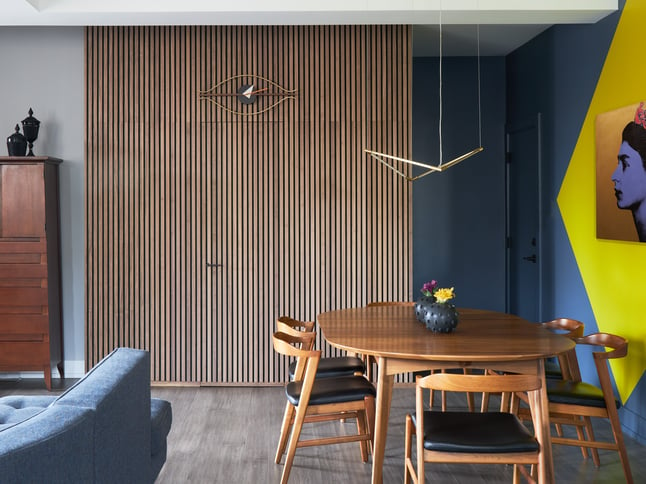 A modernist dining room designed by Jasmin Reese with wood slat and blue wall treatment, Chicago. 