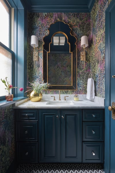 A small powder room with turquoise and pink floral wallpaper and ornate mirror - designed by Jasmin Reese Interiors, Chicago. 