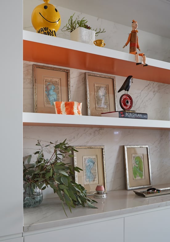 A shelf in a dining room designed by Jasmin Reese with eclectic pop art and antique toys, Chicago. 