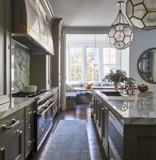 A large traditional galley kitchen with marble countertops designed by Jasmin Reese, Chicago. 