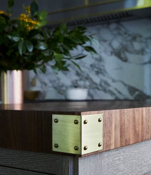 Details of brass corner hardware in a kitchen designed by Jasmin Reese, Chicago. 
