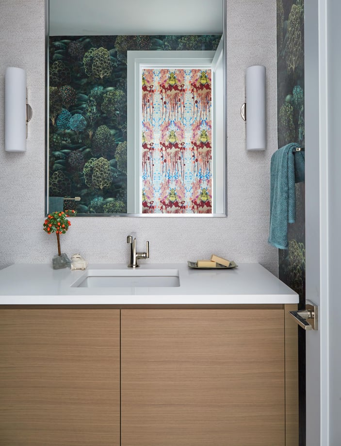  A modern single-sink vanity with a marble top & trees wallpaper - bathroom design by Jasmin Reese Interiors, Chicago, USA. 