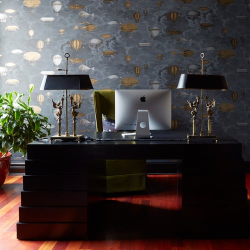 A home office with dark furniture and old-fashioned balloon foil wallpaper designed by Jasmin Reese Interiors, Chicago. 