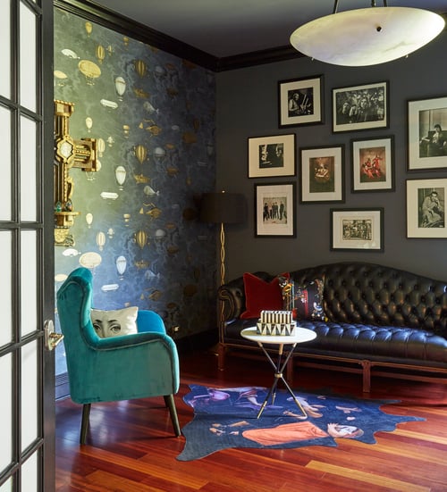 A small seating area in a home office designed by Jasmin Reese: black leather sofa, turquoise velvet chair, balloon wallpaper, Chicago. 