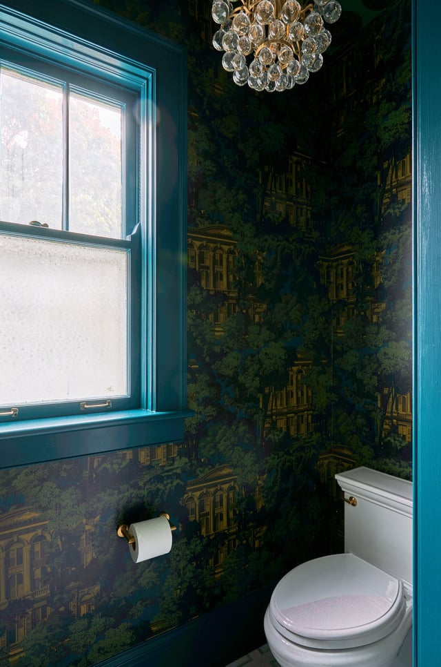 A small bathroom design by Jasmin Reese, Chicago with bold gold, green, and turquoise wallpaper and turquoise trim. 