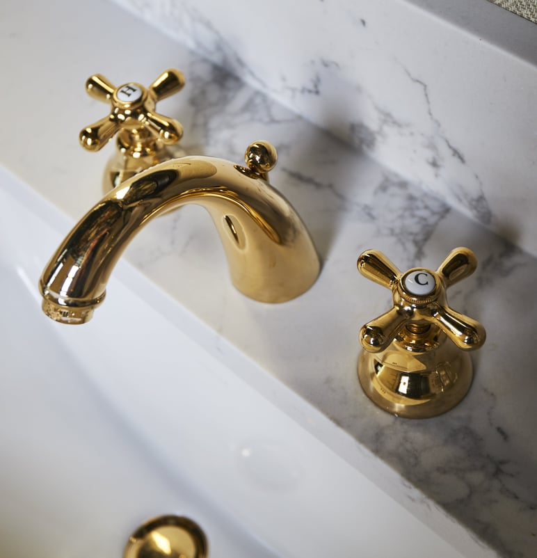 Antique style copper vanity sink fixtures on a marble sink - bathroom design by Jasmin Reese Interiors, Chicago, USA.