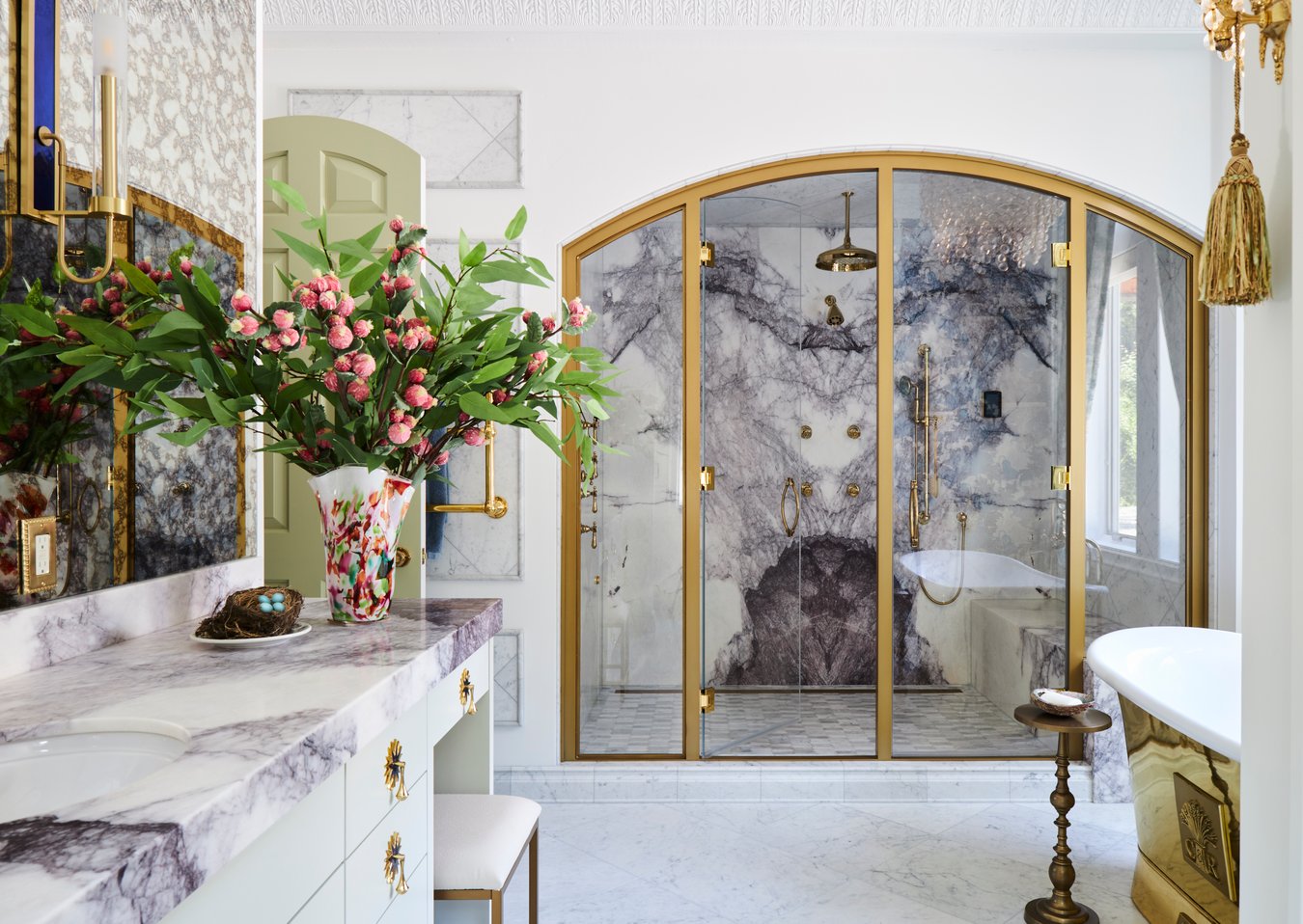 A large open white marble, brass, and glass bathroom with a large shower & brass bathtub - bathroom designed by Jasmin Reese Interiors, Chicago, USA. 
