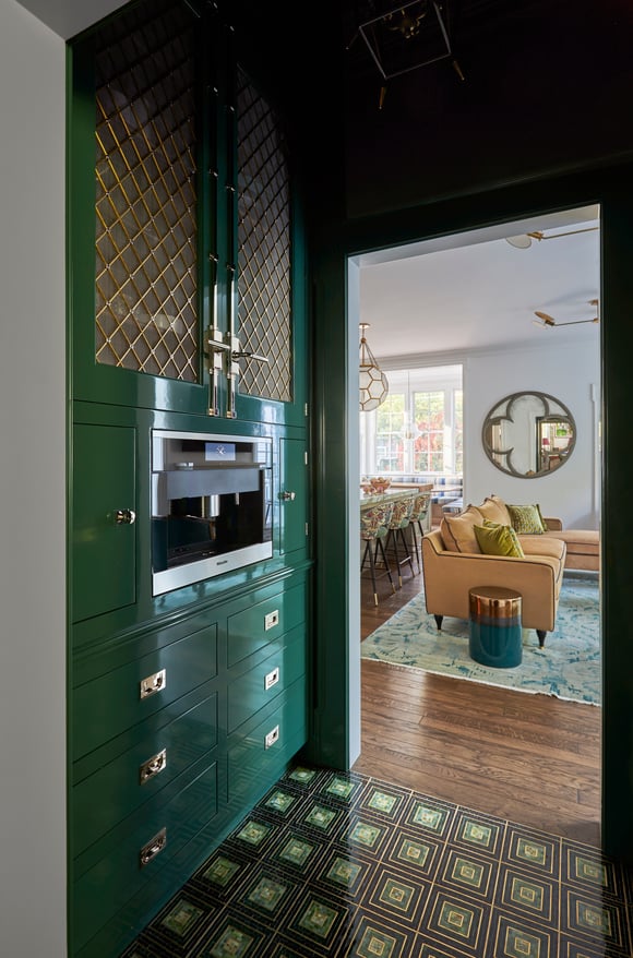A microwave station built into green metal cabinetry in a kitchen designed by Jasmin Reese, Chicago. 