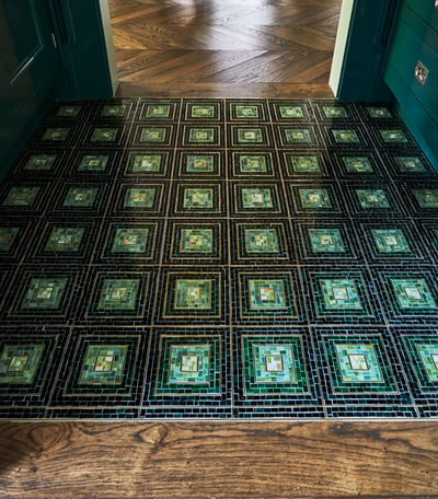 Custom tiles in shades of green in a kitchen designed by Jasmin Reese, Chicago. 