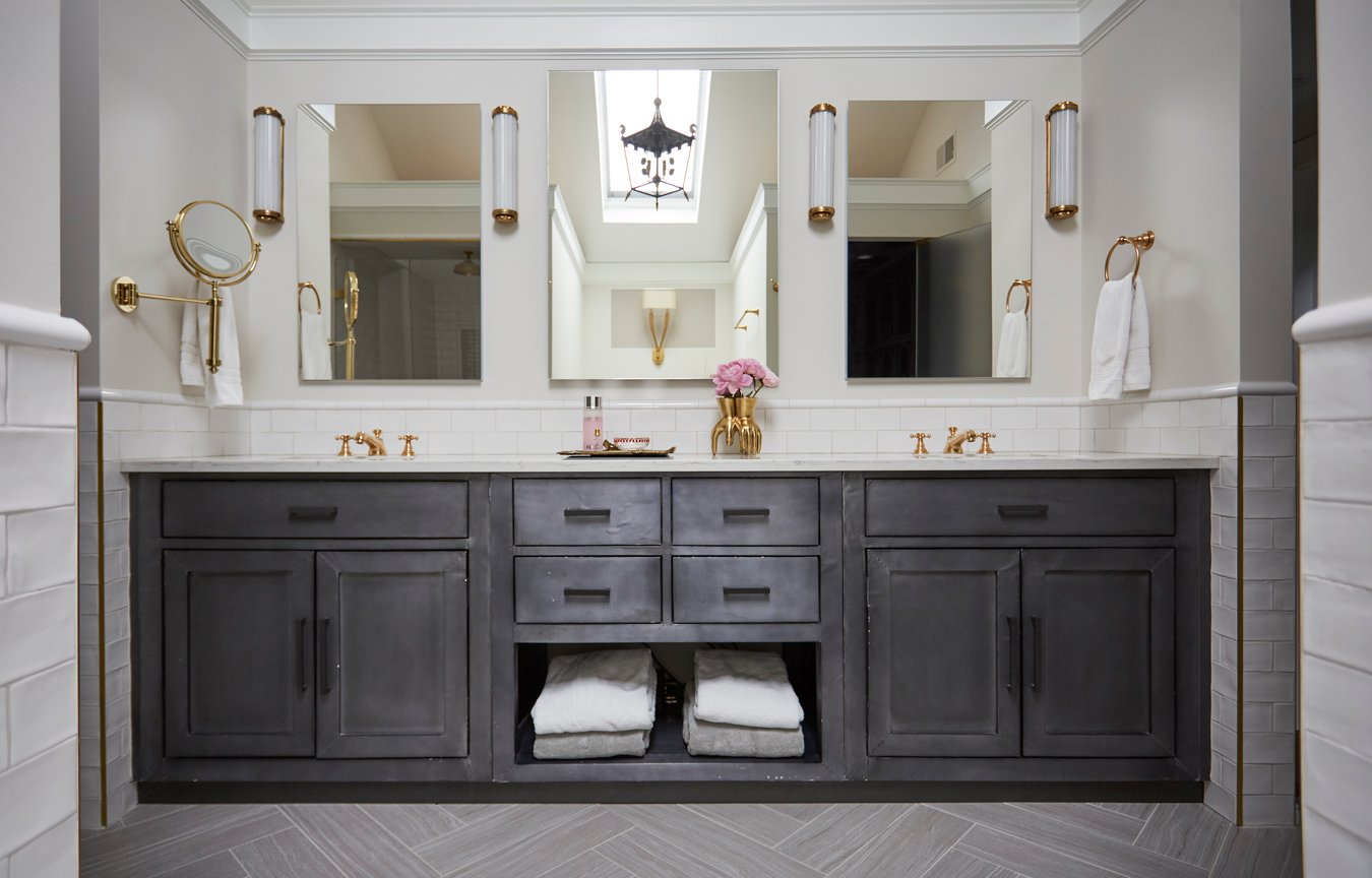 A large double sink vanity with dark wood cabinetry in a bathroom designed by Jasmin Reese, Chicago. 