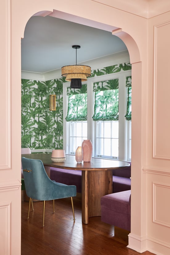 A kitchen nook designed by Jasmin Reese with a wooden table and palm wallpaper & window treatments, Chicago. 