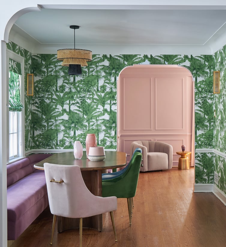 A kitchen nook designed by Jasmin Reese with purple bench seating and palm wallpaper, Chicago. 