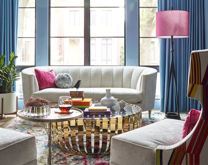Bright white sofa detail with golden basket coffee table in a bright living room designed by Jasmin Reese Interiors, Chicago, USA. design by Jasmin Reese Interiors, Chicago, USA. 