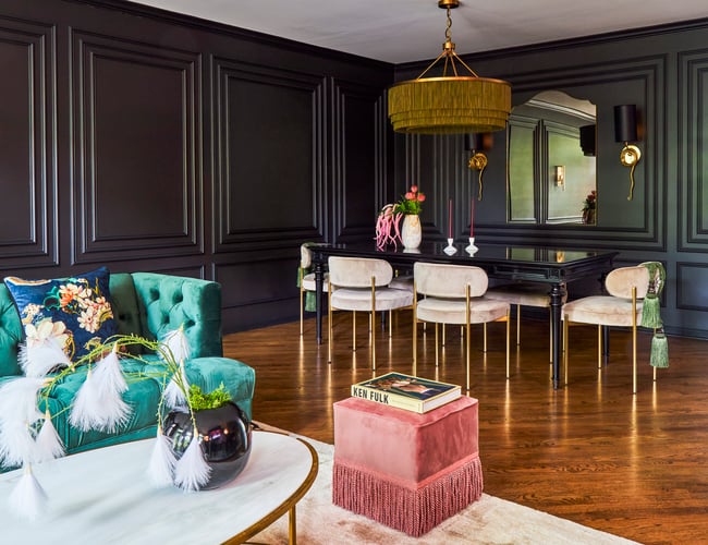 A formal dining room designed by Jasmin Reese with plush tan chairs and gold tassel chandelier, Chicago. 