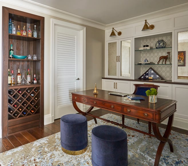 Executive home office with a dry bar designed by Jasmin Reese, Chicago: blue velvet clutch chairs, antique desk. 