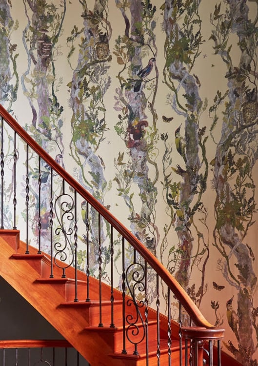 A delicate iron and wood staircase with lavender and green wood and vine wallpaper with woodland animals - living room design by Jasmin Reese Interiors, Chicago, USA. 