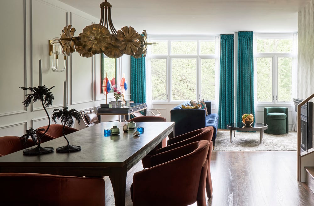 A formal dining room designed by Jasmin Reese with bright windows and green drapes, Chicago. 