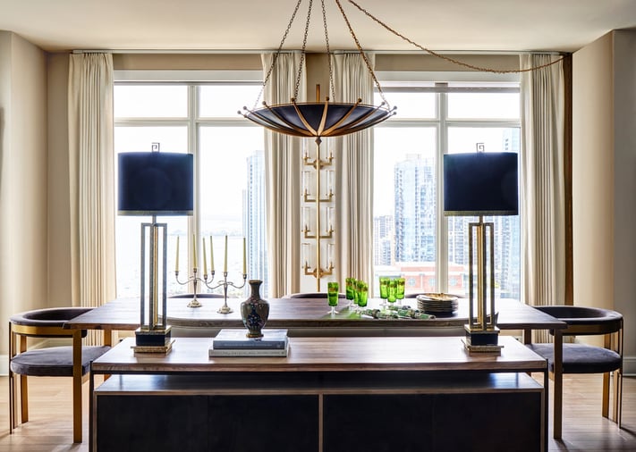 A formal dining room design by Jasmin Reese with blue, cream, gold, and brown details, Chicago. 