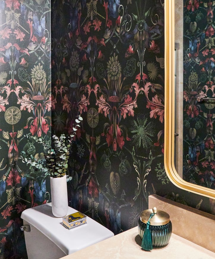 A powder room with floral wallpaper in colors of green, blue, and pink designed by Jasmin Reese, Chicago. 
