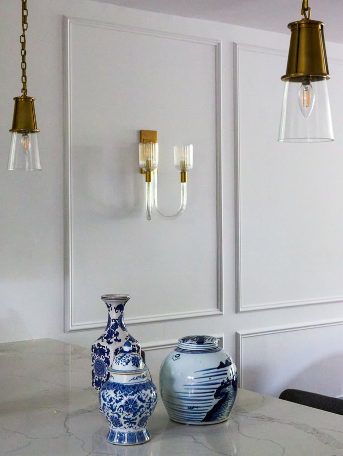 A dining room design detail by Jasmin Reese with wall sconce and Chinese blue vases, Chicago. 