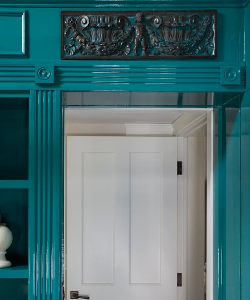 A detail of ornate crown molding with a rectangular cornice - all in turquoise slick-finish paint - living room design by Jasmin Reese Interiors, Chicago, USA. 