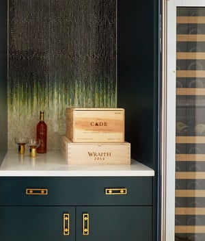 A small dry bar designed by Jasmin Reese, Chicago: tile art, marble top, unique brass fixtures, liquor boxes. 