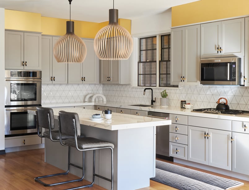 A contemporary kitchen designed by Jasmin Reese in metallic gold and subway tile white backsplash, Chicago. 