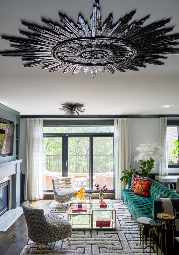 A large black sunburst design on the ceiling of an eclectic living room with a green sofa and tweed clutch chairs - living room design by Jasmin Reese Interiors, Chicago, USA. 