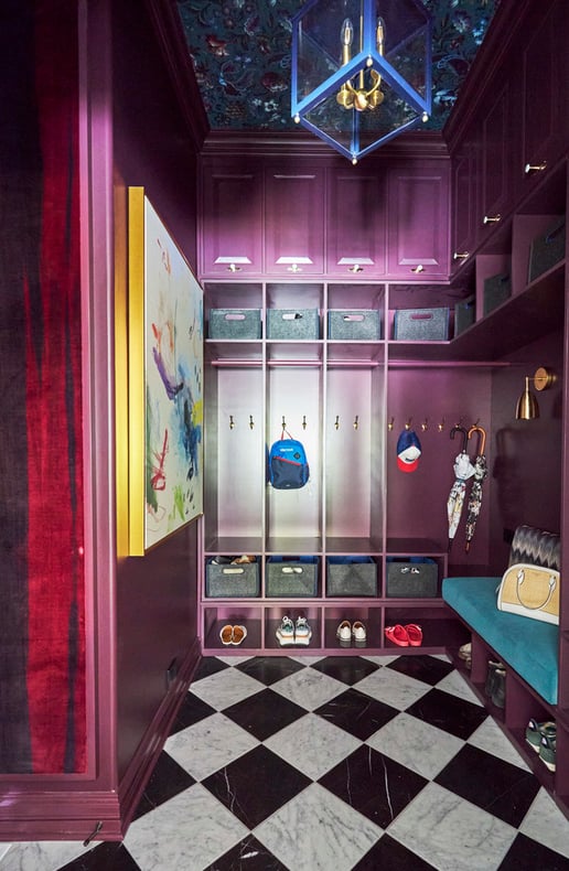 A kid's locker room style mudroom painted metallic magenta with black and white checkered marble flooring - interior design by Jasmin Reese Interiors, Chicago, USA. 
