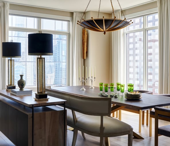 Side view of a formal dining room design by Jasmin Reese with blue, cream, gold, and brown details, Chicago. 