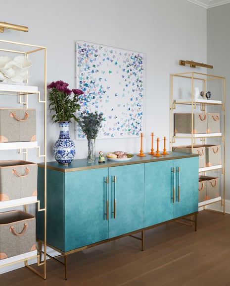 A sideboard painted turquoise in a living room designed by Jasmin Reese Interiors, Chicago. 