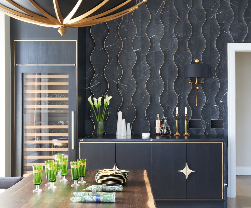 A dry bar design by Jasmin Reese in a kitchen with black and gold organic shapes, Chicago.