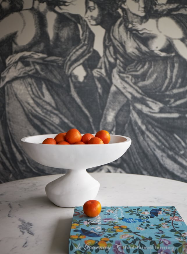 An white bowl of oranges in a dining room designed by Jasmin Reese, Chicago. 