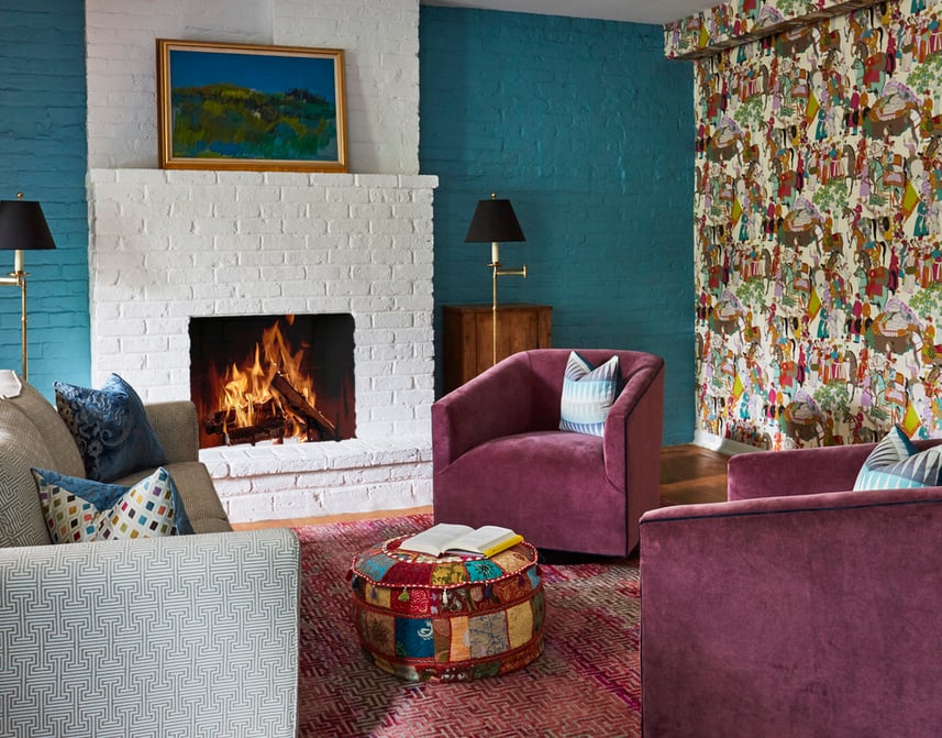 Seating area in a game room designed by Jasmin Reese, Chicago: magenta velvet, turquoise brink, colorful wallpaper. 