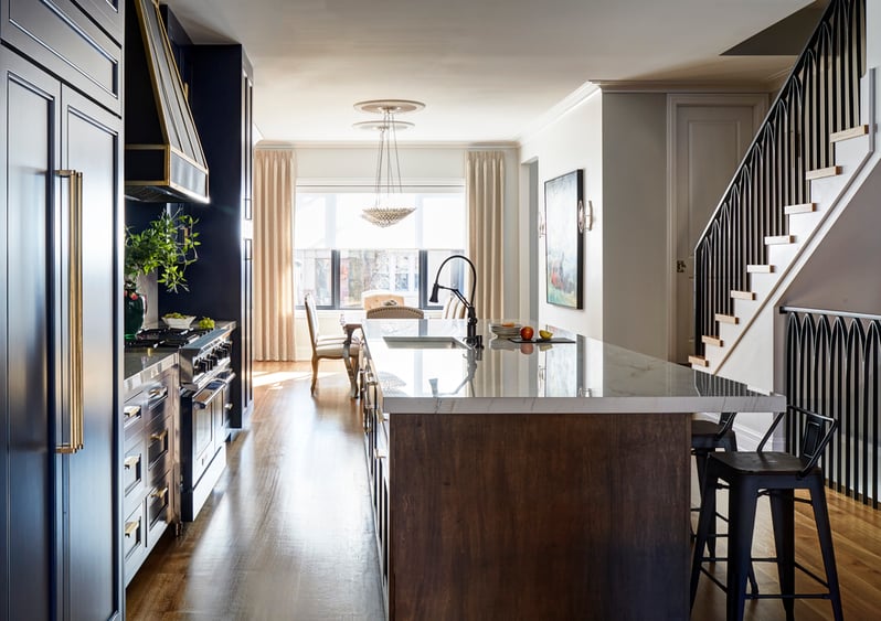 A large kitchen design by Jasmin Reese with a large marble top island, Chicago. 