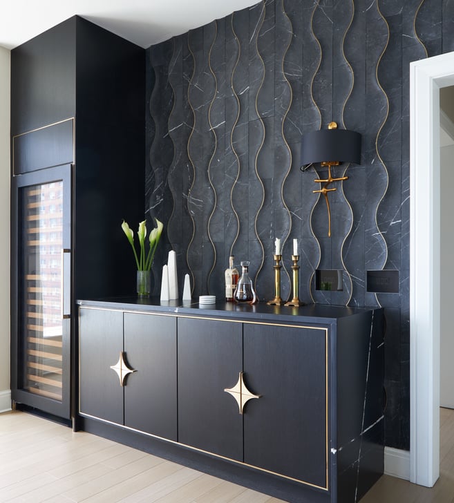 A side view of a dry bar design in a kitchen by Jasmin Reese with black and gold organic shapes, Chicago. 