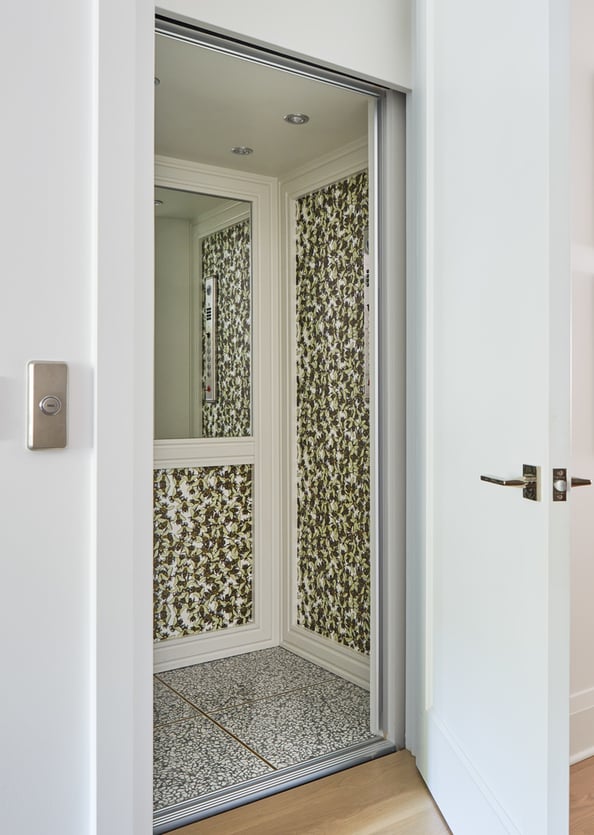 A cream and green designed private elevator designed by Jasmin Reese Interiors, Chicago. 