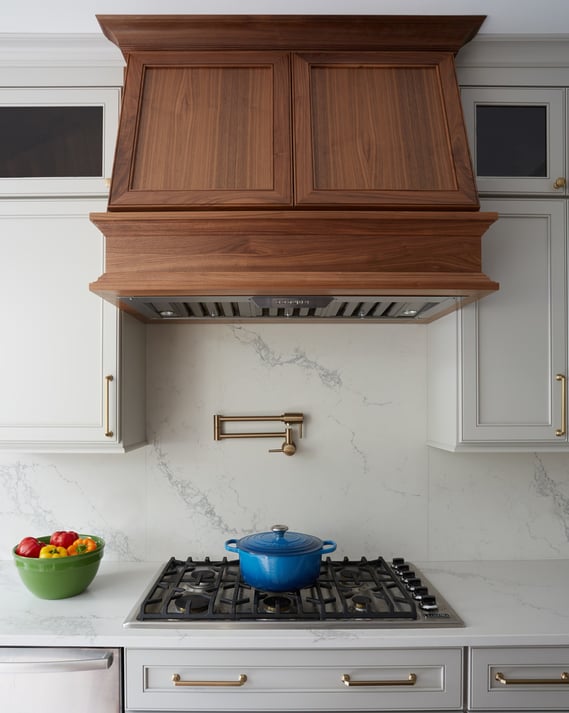Wooden range hood in a large bright galley kitchen designed by Jasmin Reese, Chicago. 