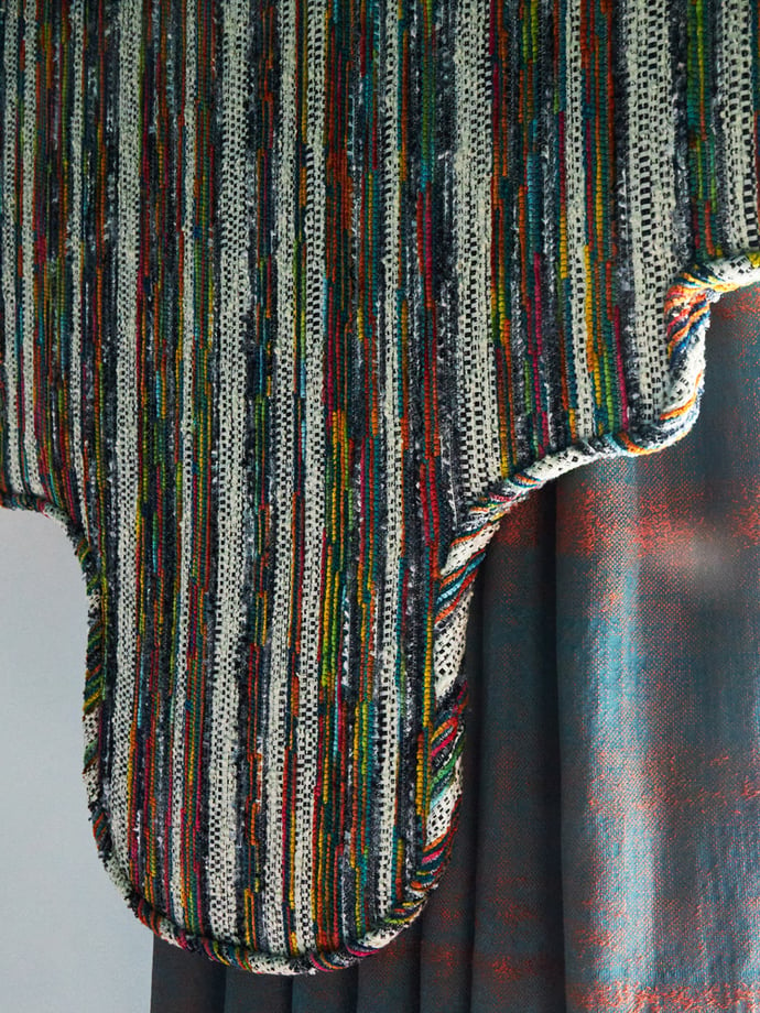 A closeup of a multicolored, upholstery valance against flannel drapes in a home - interior design by Jasmin Reese Interiors, Chicago, USA. 