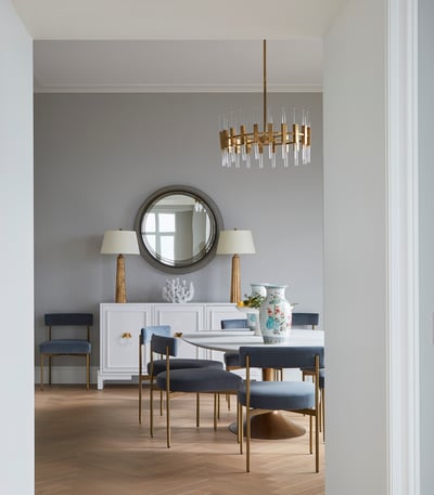 A formal living room design by Jasmin Reese with grey velvet and rose gold chairs and chandelier, Chicago. 