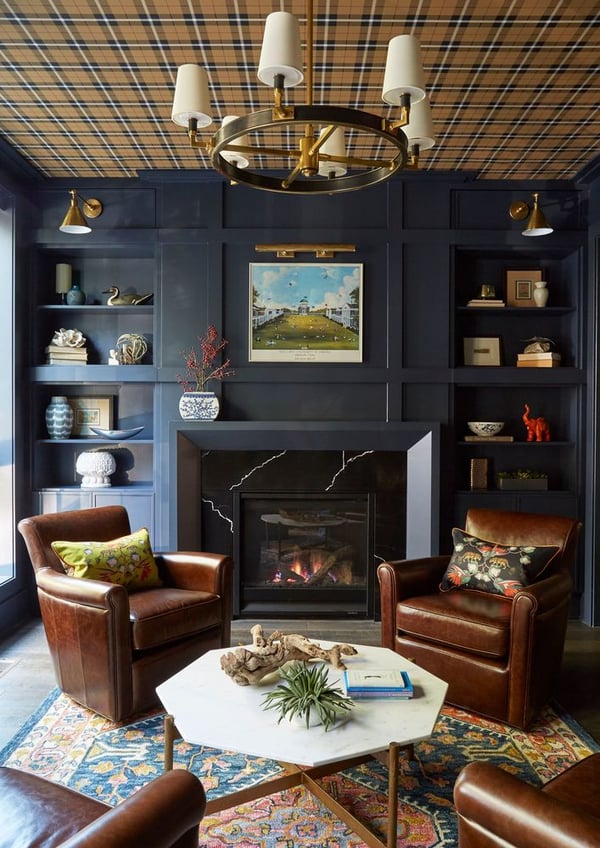 Leather chairs in front of a black matte & black marble fireplace - living room design by Jasmin Reese Interiors, Chicago, USA.  