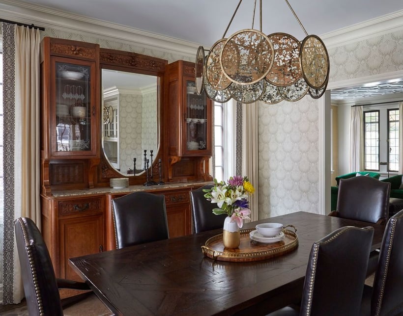 Traditional dining room by Jasmin Reese: brown leather chairs, large antique sideboard with mirror, Chicago. 