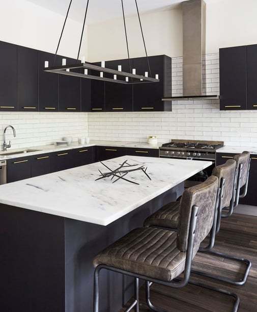 Moody Kitchen design by Jasmin Reese: black cabinetry, marble counters, leather bar stools, Chicago. 