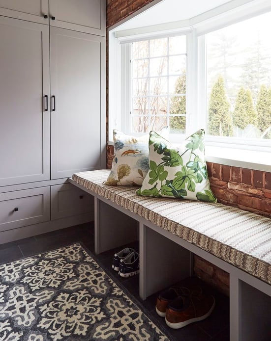 Shoe storage under the window seat in a mudroom designed by Jasmin Reese Interiors, Chicago: built-in storage. 