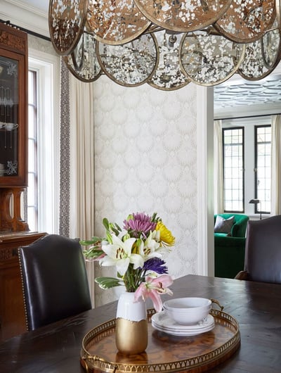 Detail of a traditional dining room by Jasmin Reese: brown leather chairs, welded metal art chandelier, Chicago. 